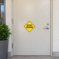 Road sign sticker with yellow diamond and black 'SCHOOL CROSSING' text