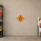 Orange diamond road sign sticker with text "THRU TRAFFIC MERGE RIGHT"