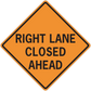 Orange road sign sticker: black text 'RIGHT LANE CLOSED AHEAD'.