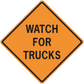 Orange road sign warning sticker with black border reading “WATCH FOR TRUCKS”