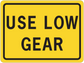 Road sign sticker, yellow with black border and text “USE LOW GEAR”