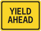Yellow road sign sticker reading "YIELD AHEAD" with black border
