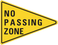 Yellow road sign sticker with black border reading "NO PASSING ZONE"