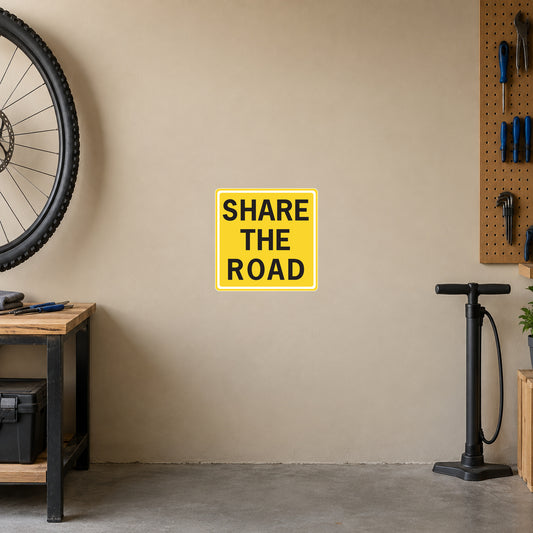 Yellow road sign sticker with "SHARE THE ROAD" text
