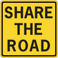 Road sign sticker, yellow square with black border and text 'SHARE THE ROAD'.