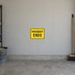 Road Sign Sticker applied in a continuous warm grey garage wall with gravel bucket and push broom at extreme sides