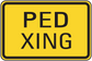 Road sign sticker showing black "PED XING" text on yellow with black border