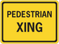 Road sign sticker with yellow background reading “PEDESTRIAN XING”