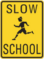 Yellow road sign sticker with black border, 'SLOW' and 'SCHOOL' and running child icon