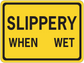 Yellow road sign sticker with black border reading "SLIPPERY WHEN WET".