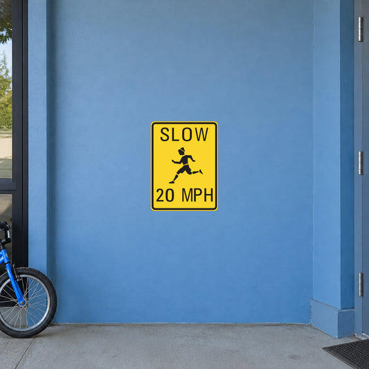 Road sign sticker with yellow “SLOW 20 MPH” warning icon and worker illustration