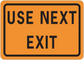 Road sign sticker with orange background and black border, text “USE NEXT EXIT”