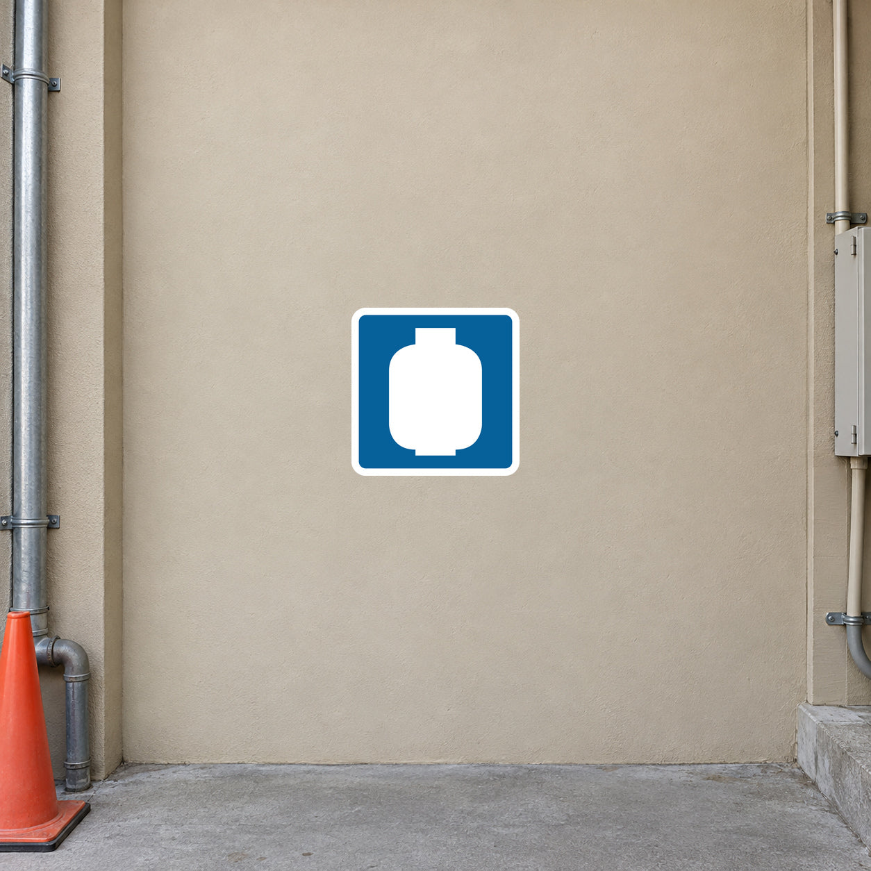 Road Sign Sticker applied in a continuous light tan industrial service passage wall with orange cone and pipework only at far edges