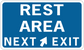 Road sign sticker with 'REST AREA' and 'NEXT EXIT' text, white on blue