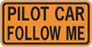 Road sign sticker with orange border and black text: 'PILOT CAR FOLLOW ME'