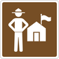 Road sign sticker with white traffic guard holding a flag near a small house