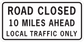 Road sign sticker reading: ROAD CLOSED, 10 MILES AHEAD, LOCAL TRAFFIC ONLY