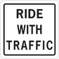 Road sign sticker: 'RIDE WITH TRAFFIC' black text on white background