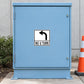 Road Sign Sticker applied in a smooth soft blue single traffic maintenance cabinet, cone at far right edge