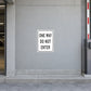 Road Sign Sticker applied in a continuous light grey parking garage entrance wall with curb at bottom and barrier arm at far right