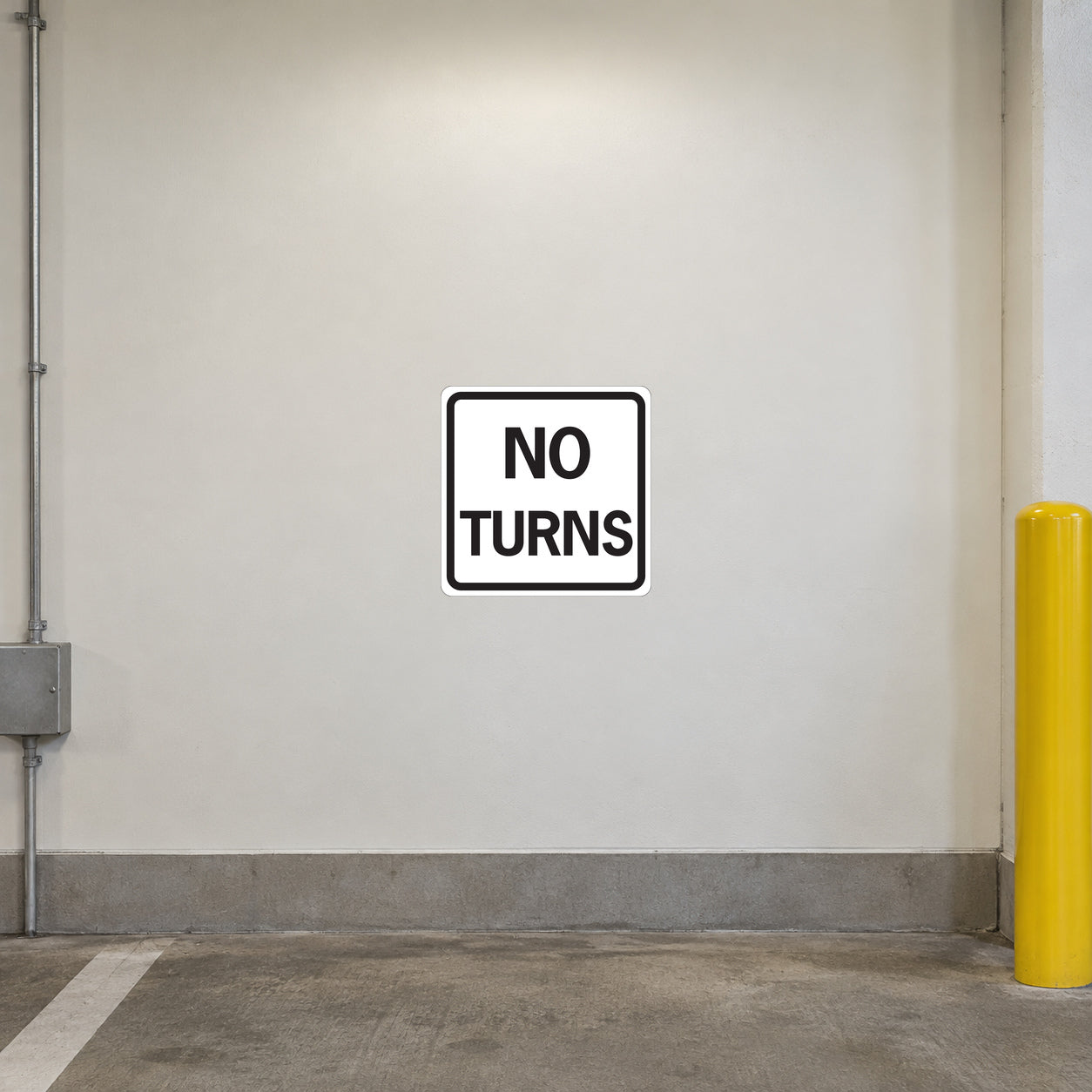 Road Sign Sticker applied in a continuous ivory parking service corridor wall with protective bollard at extreme right