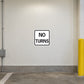 Road Sign Sticker applied in a continuous ivory parking service corridor wall with protective bollard at extreme right
