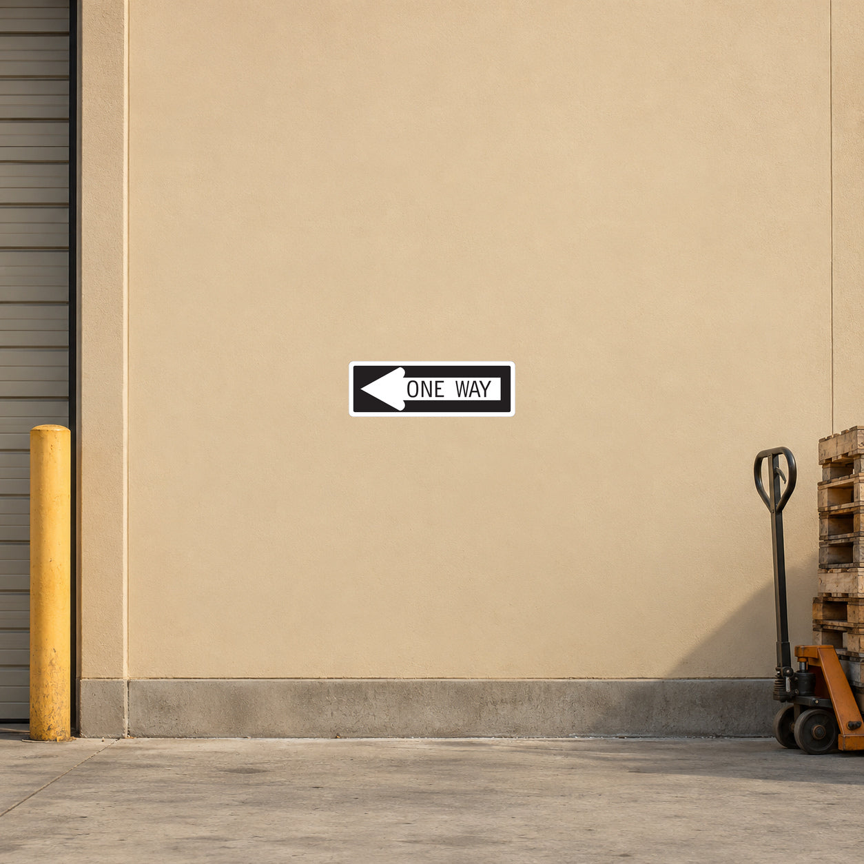 Road Sign Sticker applied in a continuous pale ochre warehouse driveway wall with curb and pallet truck at extreme sides