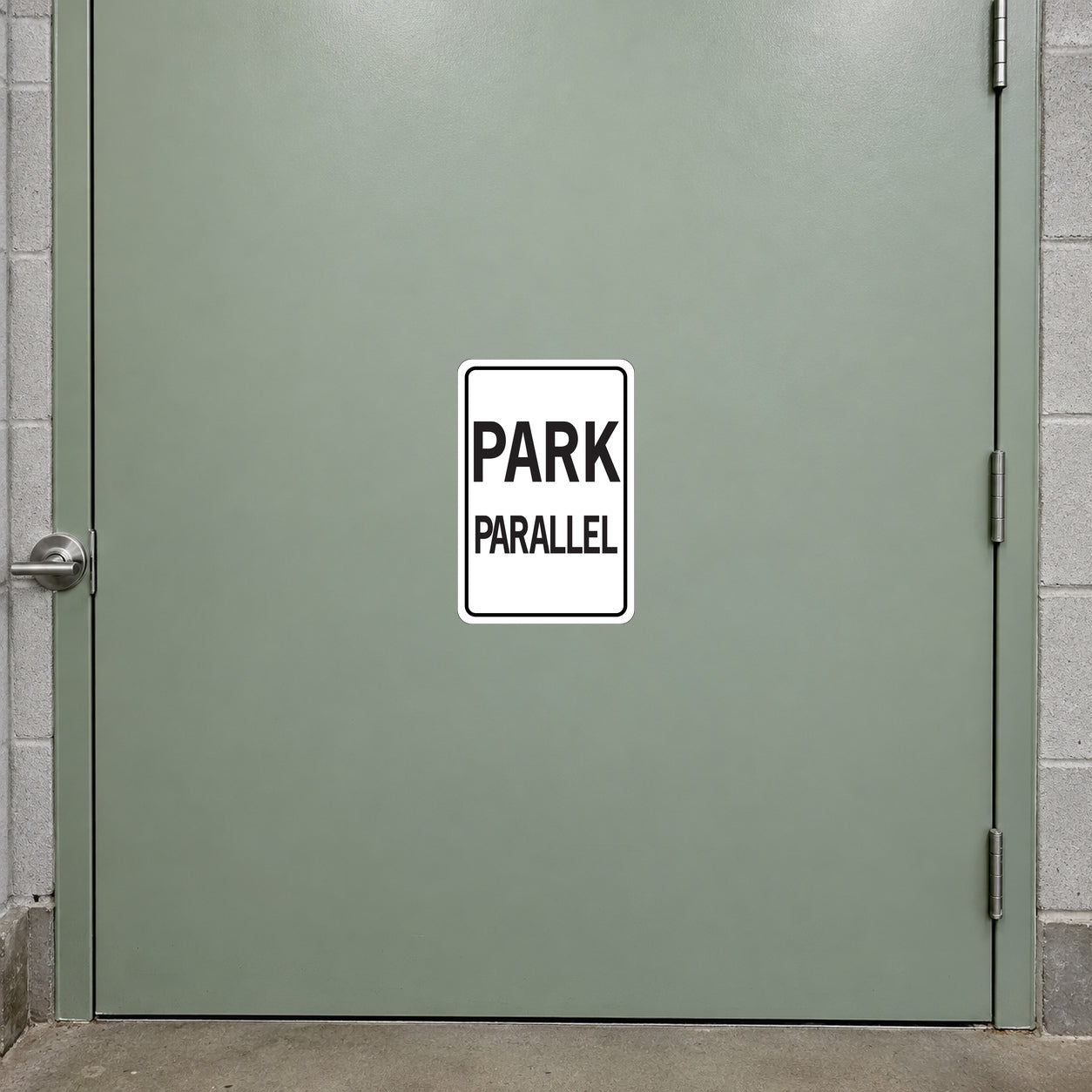 Road Sign Sticker applied in a smooth pale sage parking garage service door, handle at extreme left edge