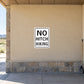 Road Sign Sticker applied in a continuous sandy beige roadside rest facility wall, broom at far right edge