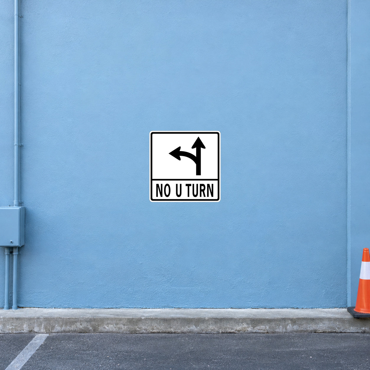 Road sign sticker showing black U-turn arrows and the text "NO U TURN"