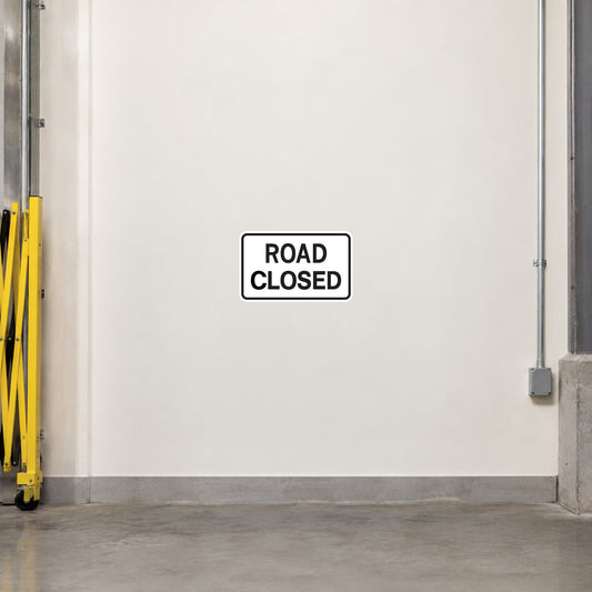 Road closed sign sticker with black text in a white bordered label