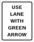Square road sign sticker with black border and 'USE LANE WITH GREEN ARROW' text