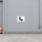 Road Sign Sticker applied in a continuous light grey distribution centre access wall with curb at bottom and cone far left