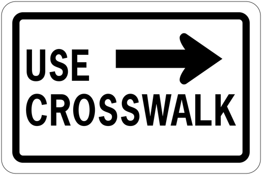 Road sign sticker reading USE CROSSWALK with right arrow