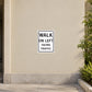 Road sign sticker with WALK ON LEFT facing traffic text, white square with black border