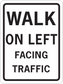 Road sign sticker with black border reading “WALK ON LEFT FACING TRAFFIC” on white background