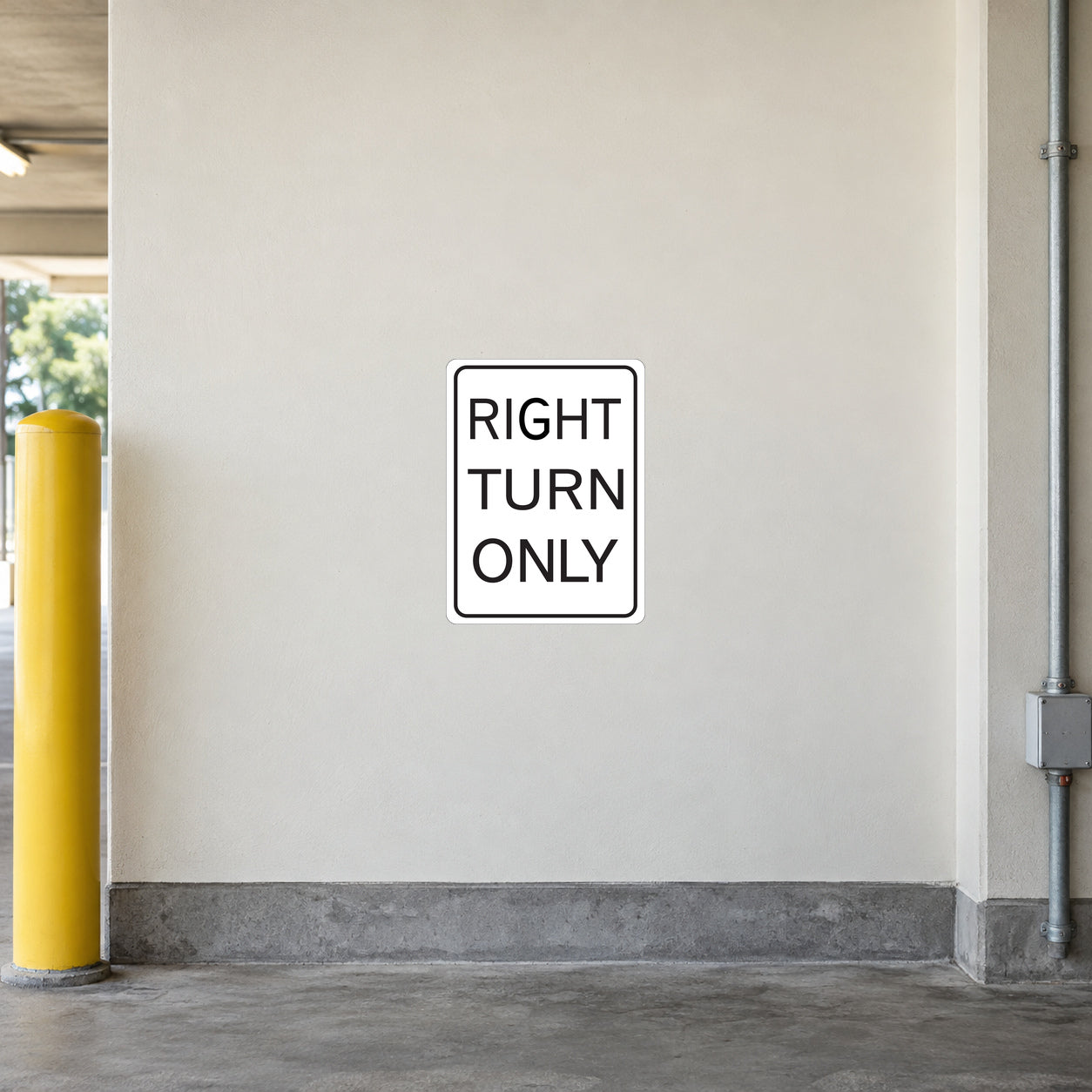 Road Sign Sticker applied in a continuous warm ivory parking access corridor wall with yellow bollard at far left