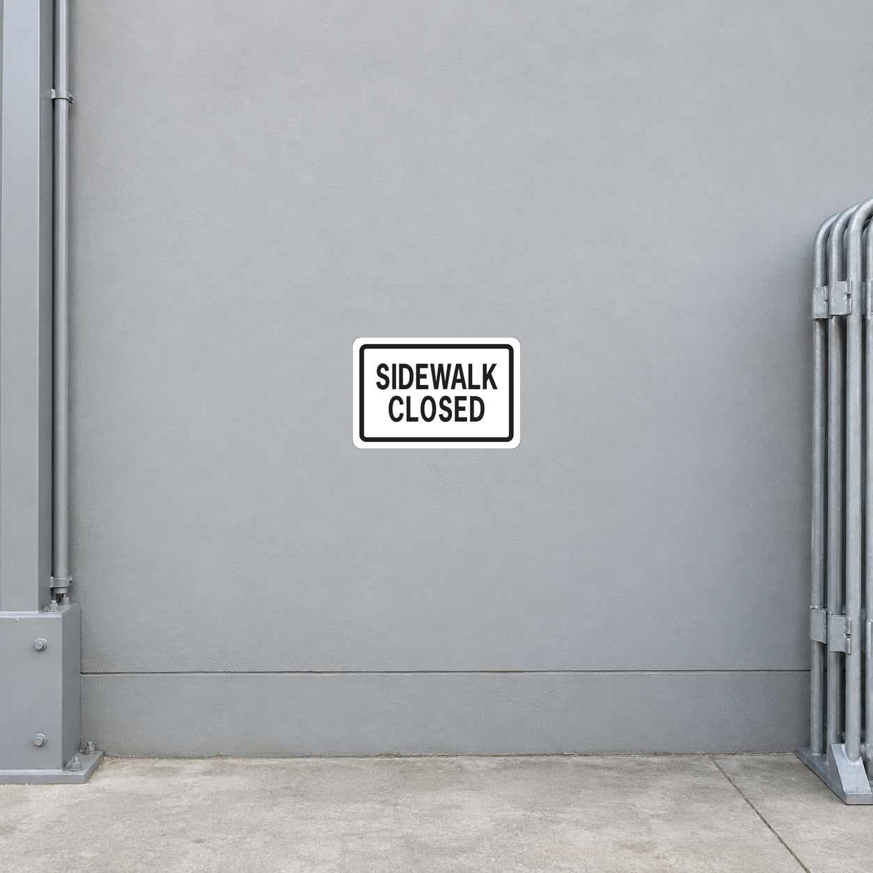 Road sign sticker: 'SIDEWALK CLOSED' on white label with black border
