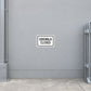 Road sign sticker: 'SIDEWALK CLOSED' on white label with black border