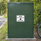 Road Sign Sticker applied in a smooth moss green single traffic maintenance cabinet near a cycle route service lane, bicycle wheel at extreme edge