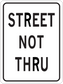 Road sign sticker with text "STREET NOT THRU" in black on a white rectangle