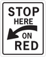 White square road sign sticker: 'STOP HERE' 'ON RED'