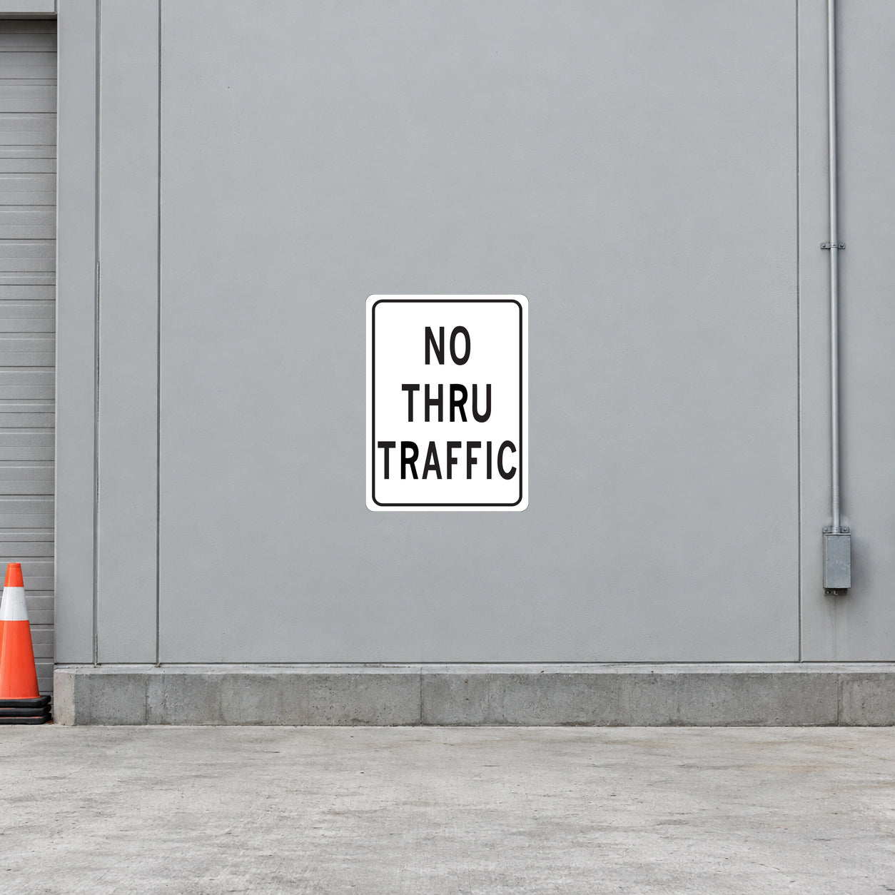 Road sign sticker reading 'NO THRU TRAFFIC' with black text and white border