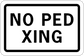 Road sign sticker: 'NO PED XING' black text on white rectangle