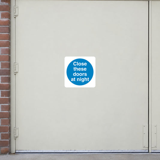 Safety sign sticker with blue circle text: 'Close these doors at night'