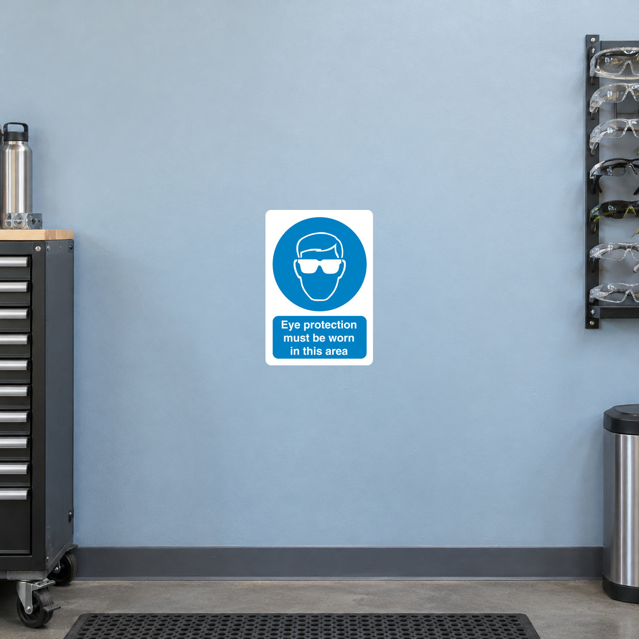Square eye protection safety sign sticker with blue goggles icon and warning text