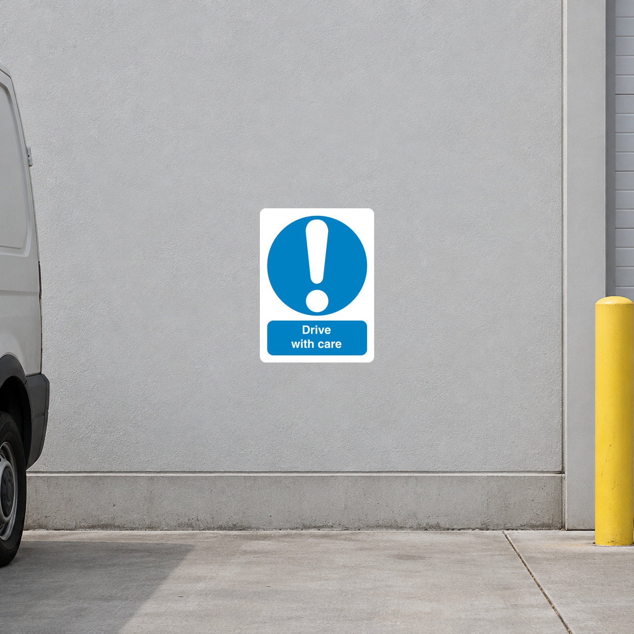 Safety sign sticker: white square with blue circle exclamation mark and text “Drive with care”