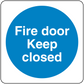 Safety sign sticker with blue circle reading 'Fire door Keep closed'