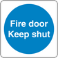 Safety sign sticker with blue circle and white text: Fire door Keep shut