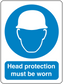 Safety sign sticker: blue circle with white helmet icon; 'Head protection must be worn'.